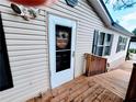 This lovely home has a bright white front door and wood deck at 3735 Fir Dr, Buford, GA 30518