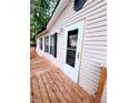 This home has a bright white front door, and exterior beige vinyl siding at 3735 Fir Dr, Buford, GA 30518