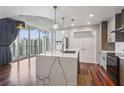 The kitchen features a large island with pendant lighting, quartz countertops, and stainless appliances at 860 Peachtree Ne St # 1417, Atlanta, GA 30308