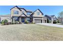 Handsome two story brick home with three car garage and professionally landscaped front yard at 2705 Fox Hunt Way, Cumming, GA 30041