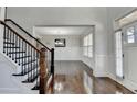 Welcoming foyer features hardwood floors, staircase with iron spindles, and a view into the dining room at 2705 Fox Hunt Way, Cumming, GA 30041