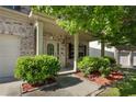 Welcoming entryway of brick home with beautiful landscaping and manicured bushes at 2984 Gayle Manor Ln, Snellville, GA 30078