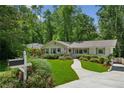 Charming single story home with a well-maintained front lawn and mature landscaping at 389 Valley Brook Ne Dr, Atlanta, GA 30342