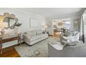 Bright living room featuring hardwood floors, neutral paint, stylish furniture, and an open floor plan at 389 Valley Brook Ne Dr, Atlanta, GA 30342