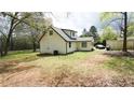 Expansive backyard featuring mature trees, room for outdoor activities, and potential for landscaping at 2638 Cleburne Pkwy, Powder Springs, GA 30127