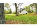 Spacious backyard with well-maintained lawn, mature trees, and space for recreation and outdoor activities at 2638 Cleburne Pkwy, Powder Springs, GA 30127