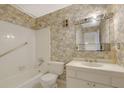 Bathroom with tub/shower combo, wallpaper, mirror, vanity, and commode at 3312 Northcrest Rd # C, Atlanta, GA 30340
