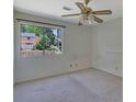 Bedroom with view of exterior landscape, ceiling fan, and tan carpet at 3312 Northcrest Rd # C, Atlanta, GA 30340