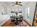 Cozy dining room with a round table, modern light fixture, and a sunlit window at 3689 Essex Ave # 16, Atlanta, GA 30339