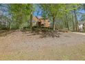 Lovely brick home nestled among mature trees and lush landscaping at 4650 Riversound Dr, Snellville, GA 30039