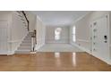 Inviting living room featuring hardwood floors, a staircase, and a modern light fixture at 4650 Riversound Dr, Snellville, GA 30039