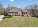 Well-maintained brick home with a spacious front lawn, mature landscaping, and a side-entry garage at 503 Clearwater Dr, Mcdonough, GA 30252