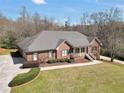 Beautiful brick home with a manicured lawn, mature trees, and a spacious driveway at 503 Clearwater Dr, Mcdonough, GA 30252