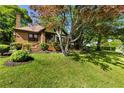 Brick home featuring a tidy landscaped yard with mature trees offering plenty of shade at 1029 Katherwood Sw Dr, Atlanta, GA 30310