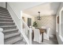 Inviting dining room featuring stylish wainscoting and elegant modern chandelier at 118 Bellington Dr, Mcdonough, GA 30253