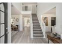 Bright entryway with staircase, light grey flooring and open view of the living areas at 118 Bellington Dr, Mcdonough, GA 30253