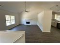 Open-concept living area boasting a fireplace, natural light, and updated flooring at 2322 Rock Mill Ne Ln, Conyers, GA 30013
