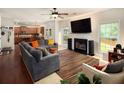 Cozy living room with a fireplace, hardwood floors, and ample natural light at 3070 Jardin Nw Ln, Kennesaw, GA 30152