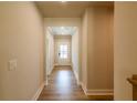 Bright hallway with hardwood floors leading into the home, and an entry door at the end at 3962 Adler Cir, Buford, GA 30519