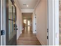 Bright hallway with hardwood floors leading into the home, and a view of the staircase at 3962 Adler Cir, Buford, GA 30519