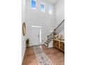 Grand foyer with soaring ceilings, wood floors, and staircase at 137 Bastian Rd, Mcdonough, GA 30252