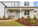 Inviting front porch with seating and manicured landscaping at 137 Bastian Rd, Mcdonough, GA 30252