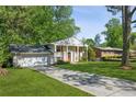 Traditional home with an attached garage, brick facade, and a well-manicured front lawn at 2202 Green Forrest Dr, Decatur, GA 30032
