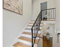 Bright staircase with oak treads, white risers, and decorative iron railing at 2202 Green Forrest Dr, Decatur, GA 30032