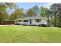 Lovely one-story home with gray brick, wood shutters, and well-maintained lawn at 974 Shirley Se St, Smyrna, GA 30082