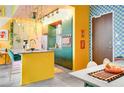 Bright kitchen boasts yellow and green cabinets, modern appliances, and unique patterned walls at 130 Arizona Ne Ave # 415, Atlanta, GA 30307