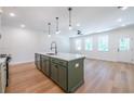 Bright, open kitchen with an island, modern pendant lights, and stainless appliances at 1616 Ruskin Way, Marietta, GA 30062