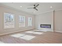 Bright living room with modern fireplace, recessed lighting, ceiling fan and wood floors at 1616 Ruskin Way, Marietta, GA 30062