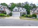 Charming two-story home featuring a two-car garage, well-manicured landscaping, and inviting curb appeal at 521 Mirramont Pl, Woodstock, GA 30189