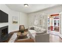 Bright living room featuring a fireplace, neutral color palette, and access to an outdoor balcony at 746 N Highland Ne Ave # 6, Atlanta, GA 30306