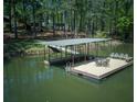 Large dock over the water with seating and boat parking at 934 Pine Cir, Woodstock, GA 30189