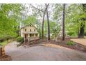 A beautiful, well-maintained home is partially visible beyond the treeline at 1745 Mary Lou Ln, Atlanta, GA 30316