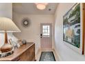 Inviting entryway with light wood flooring, modern decor, and a stylish accent mirror at 2685 Maple Park Pl # 27, Cumming, GA 30041