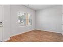 Bright bedroom with hardwood floors, two windows, and neutral paint ready for personalization at 288 Overlook Rd, Covington, GA 30014
