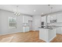 Open-concept kitchen with a center island, stainless steel appliances, and modern white cabinetry at 288 Overlook Rd, Covington, GA 30014