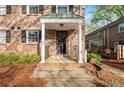 Covered brick porch with white columns, steps and a black metal railing at 6700 Roswell Rd # 20D, Sandy Springs, GA 30328