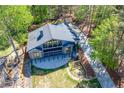 Aerial view of a modern home with a long driveway and wooded surroundings at 1762 Green Rd, Buford, GA 30518