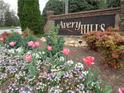 Avery Hills community sign surrounded by colorful flowers and lush greenery at 1835 Morning Star Ln, Tucker, GA 30084