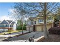 Attractive townhome complex with garages and brick accents, complemented by mature trees and landscaping at 2840 Smith Ridge Trce, Peachtree Corners, GA 30071