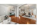 Open floor plan with dining area featuring modern lighting and hardwood floors at 1888 Fox Chapel Se Dr, Smyrna, GA 30080