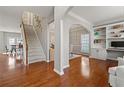 Open-concept living space with hardwood floors, staircase, and built-in shelving at 1888 Fox Chapel Se Dr, Smyrna, GA 30080