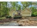 Charming single-story home featuring a well-maintained front yard and attached garage at 230 Oakmere Dr, Alpharetta, GA 30009