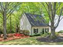 A charming house with fresh landscaping, a green lawn, and trees surrounding the home at 1153 Haven Brook Ln, Brookhaven, GA 30319