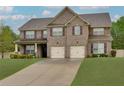 Elegant home boasts brick facade, attached two-car garage, and lush front lawn at 257 Ironwood Dr, Stockbridge, GA 30281