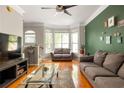 Bright living room featuring hardwood floors, bay windows and stylish furniture at 375 Highland Ne Ave # 508, Atlanta, GA 30312