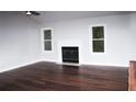 Bright living room featuring hardwood floors, a fireplace, and large windows at 4907 Windsor Downs Dr, Decatur, GA 30035
